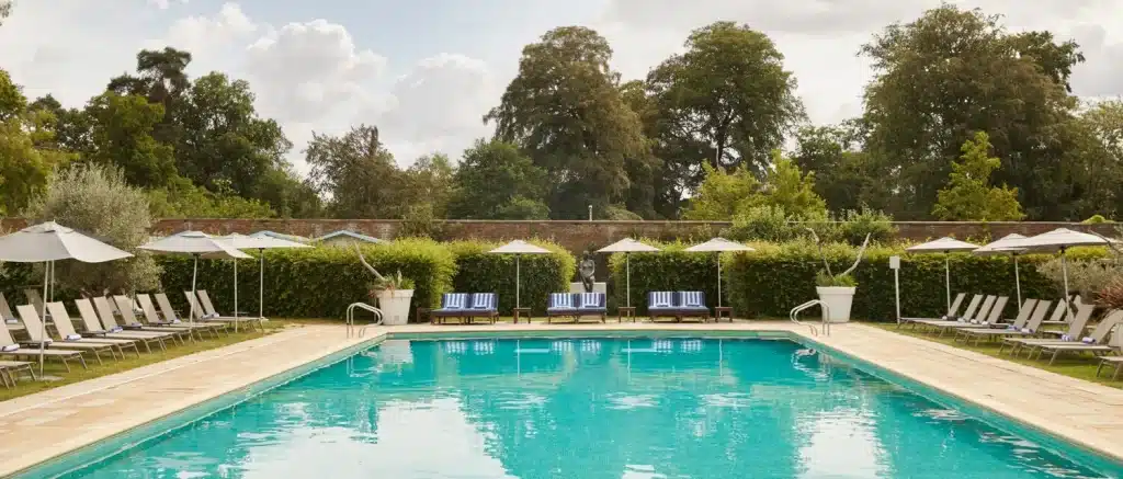 family hotels with swimming pools in UK for luxury family staycation - the grove hotel outdoor pool in Hertfordshire